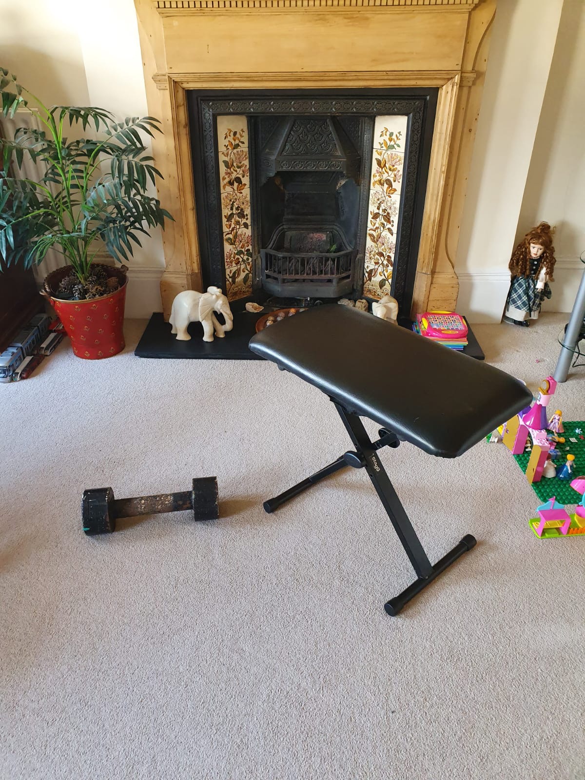 My home gym setup with workout bench and dumbbell